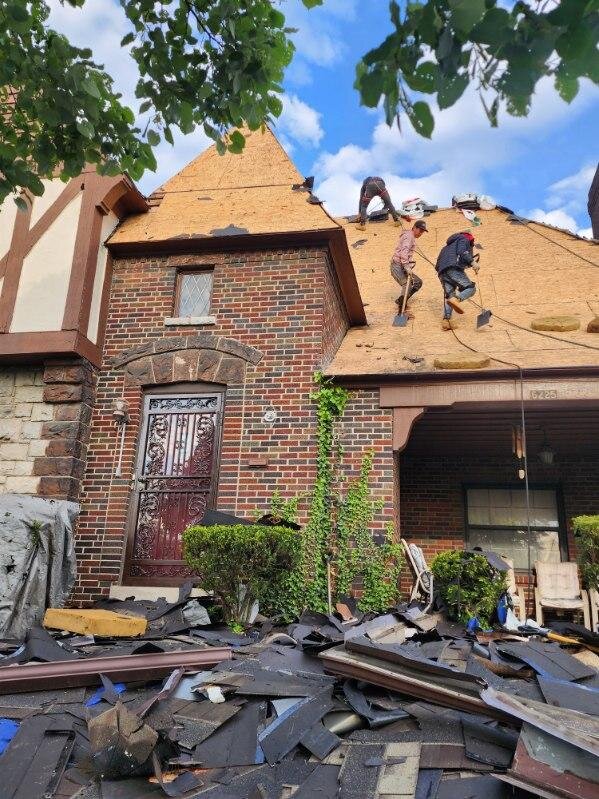 Tear-off in progress on a Cincinnati Tudor home revealing the original deck