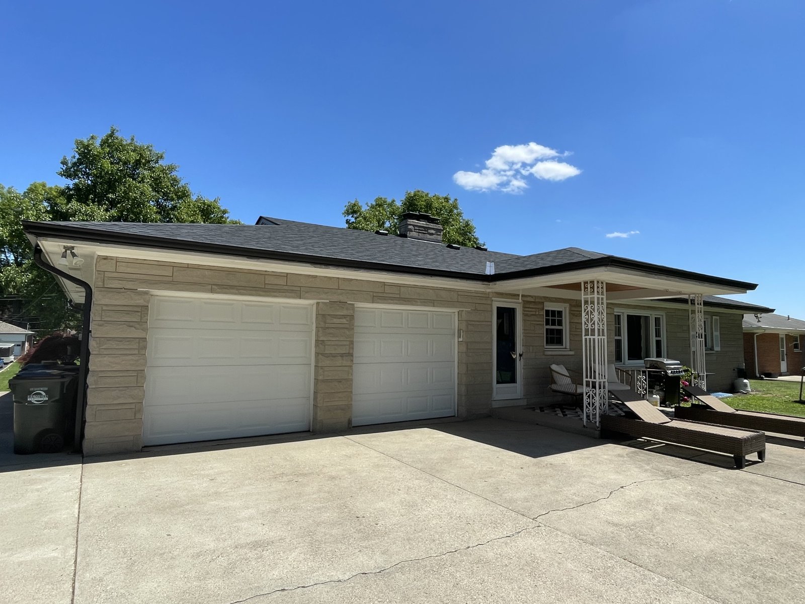 Stone-veneer ranch home in Cincinnati after new seamless gutter installation by Gutter Buddy