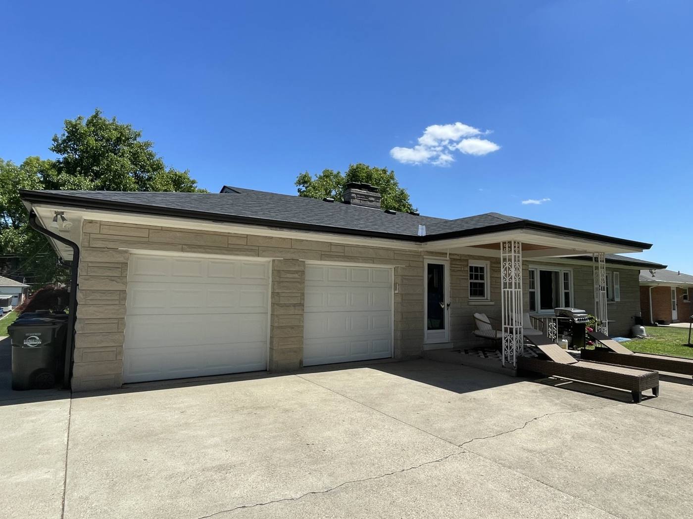 Stone-veneer ranch home in Cincinnati after new seamless gutter installation by Gutter Buddy